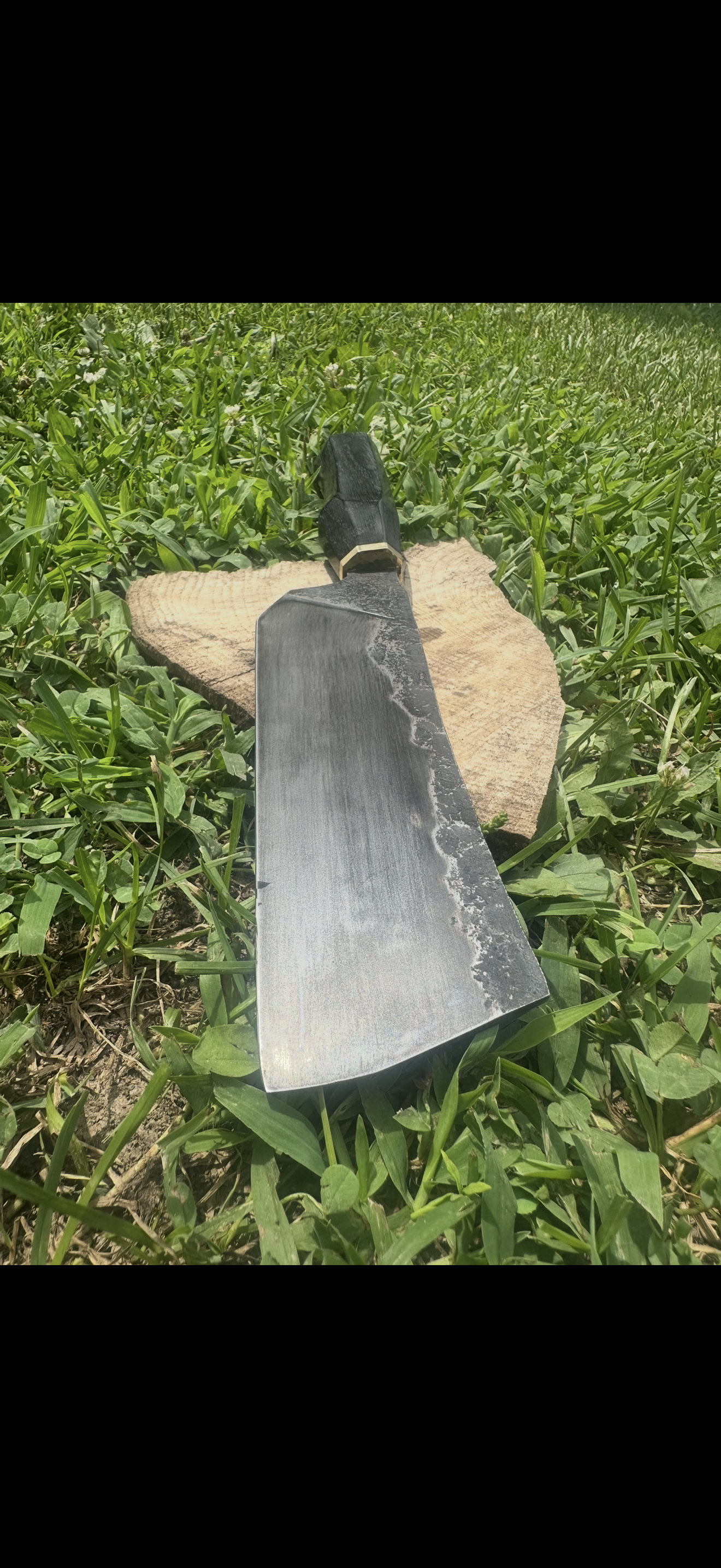 Cleaver-style blade on wood round in grass