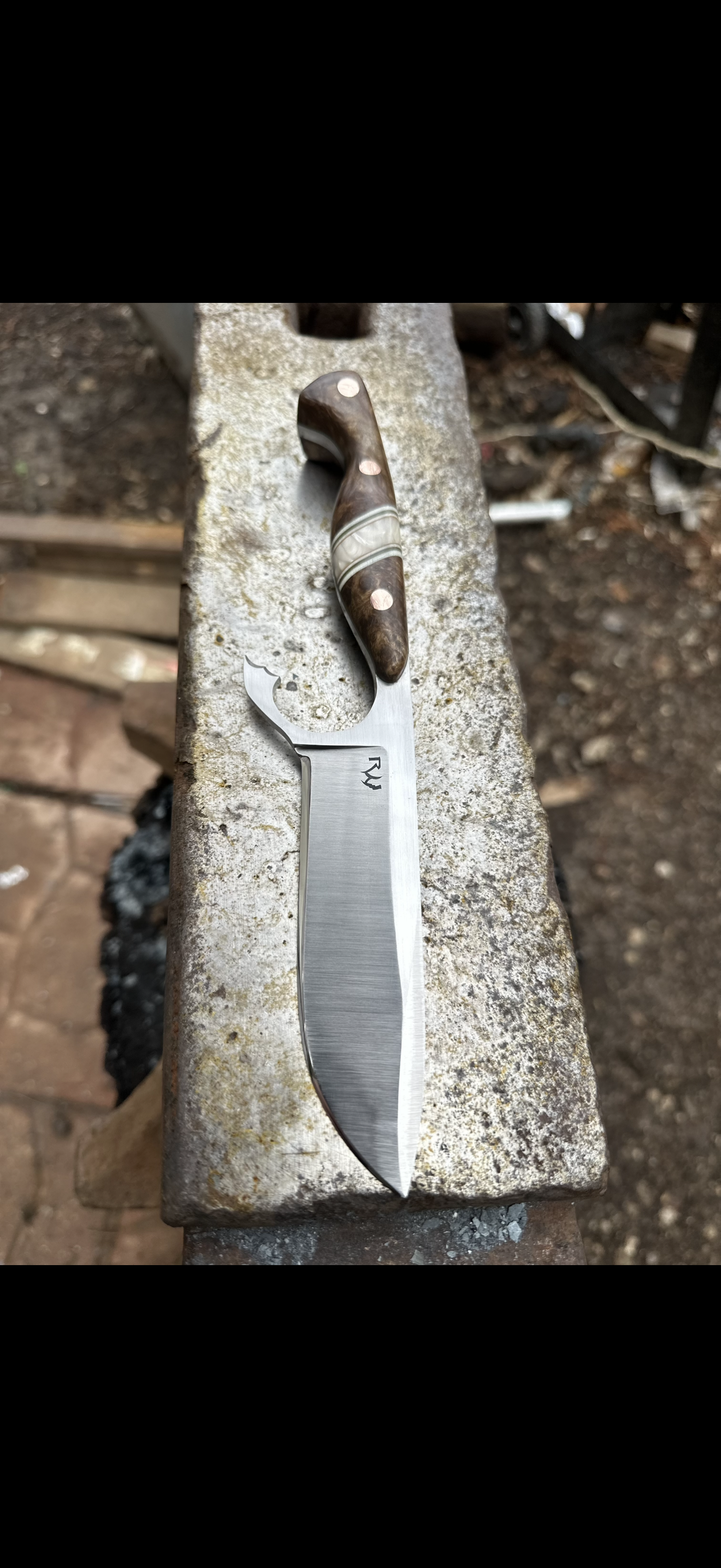 Drop-point hunter on anvil at the forge