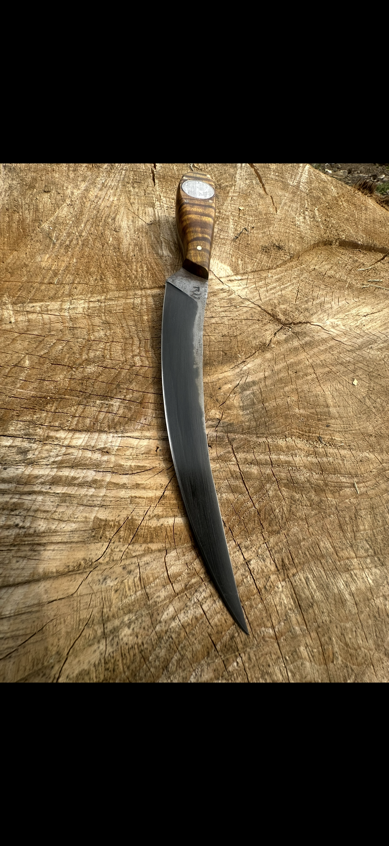 Long blade knife on wood